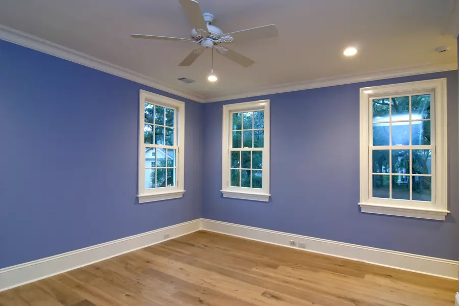 Empty room with freshly painted blue walls and white trim