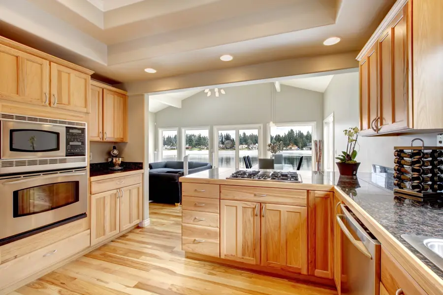 Finished kitchen with maple cabinets and a hardwood floor